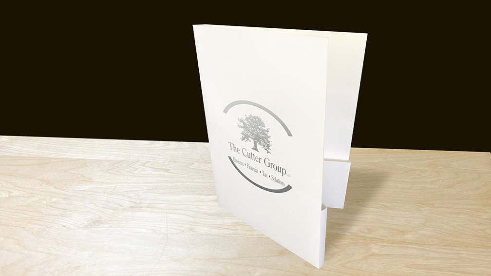 The Cutter Group's authoritative custom capacity linen folders with silver foil stamping.